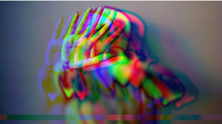 Rozmyta postać z wyciągnięta dłonią w geście STOP